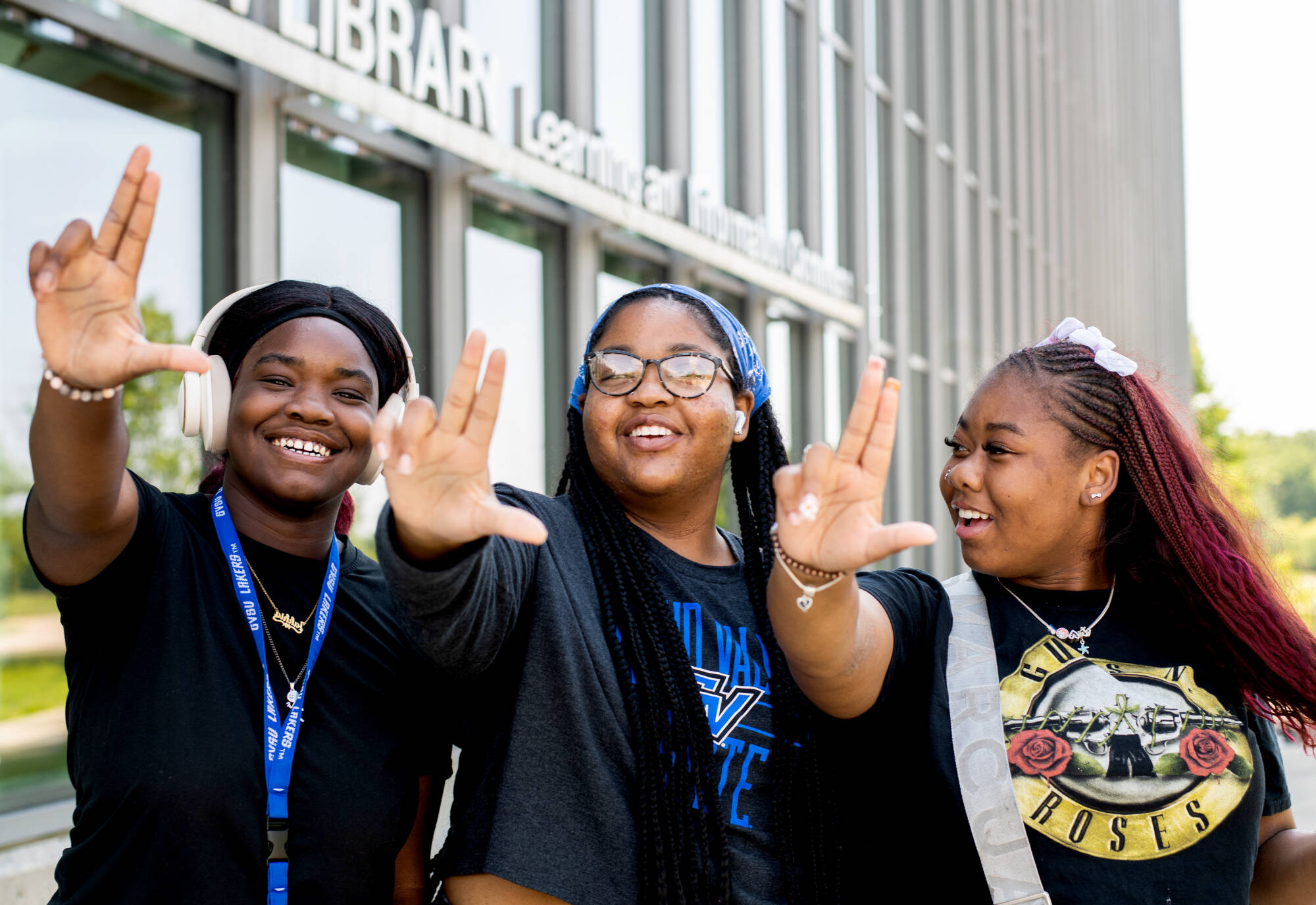 First-year students, from left, communications major Jakhia Johnson, fine arts major Ka’Maria Nathan, and art education major J’Nya Brown pose for a photo as they left their Navigating College Success class held at the Mary Idema Pew Library July 2...